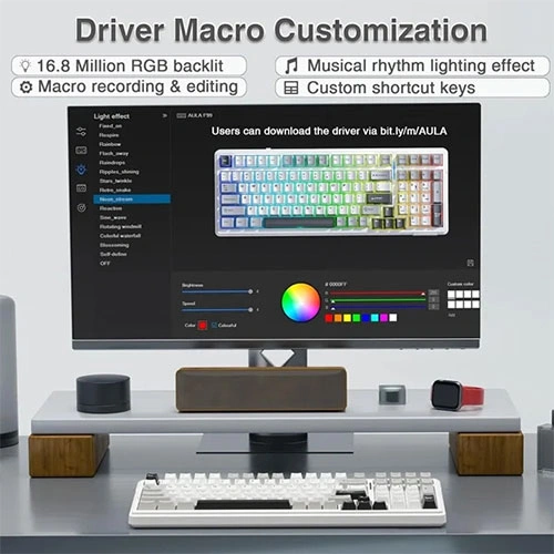 Aula-f99-tri-mode-rgb-mechanical-gaming-grey-white-keyboard-with-graywood-switches-08 Desktop setup with a monitor showing keyboard customization software—color palette, lighting controls, macros, and shortcut keys.